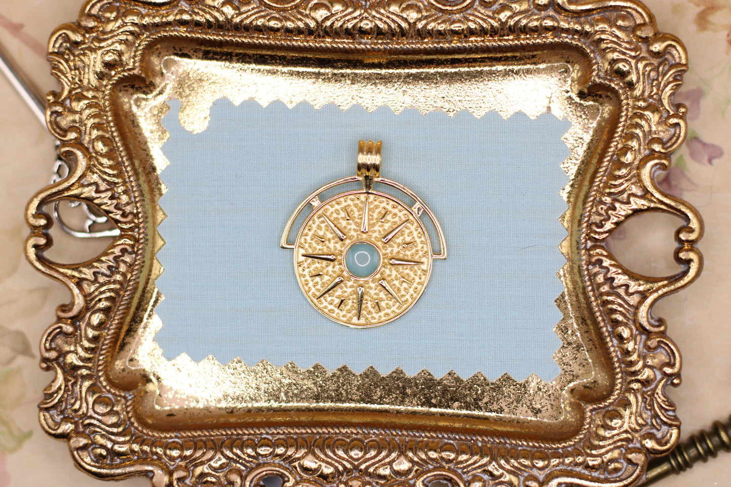 The Sun pendant featuring fabric from Elvis owned clothing with letter of authenticity